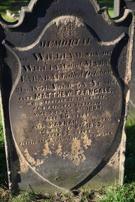 A tombstone with text on it
Description automatically generated